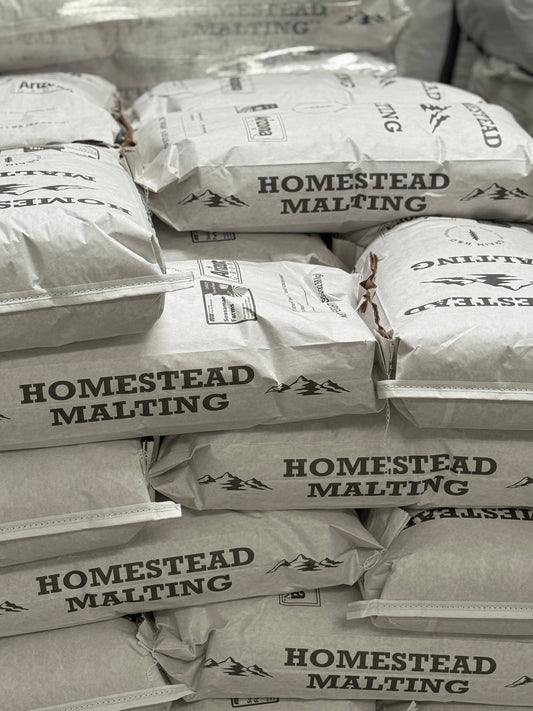 Stacked 50-lb Homestead Malting bags in the Queen Creek malthouse — Arizona Heritage Pale first release malting now